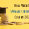 This image displays a stack of coins topped with a graduation cap against a yellow background, with the text "How Much Does VMware Certification Cost in 2025?" emphasizing the costs of VMware certification in that year.